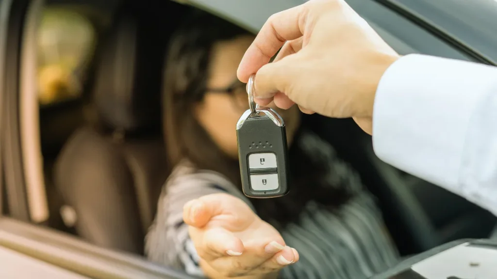 Car buyer signing finance paperwork at a car dealership