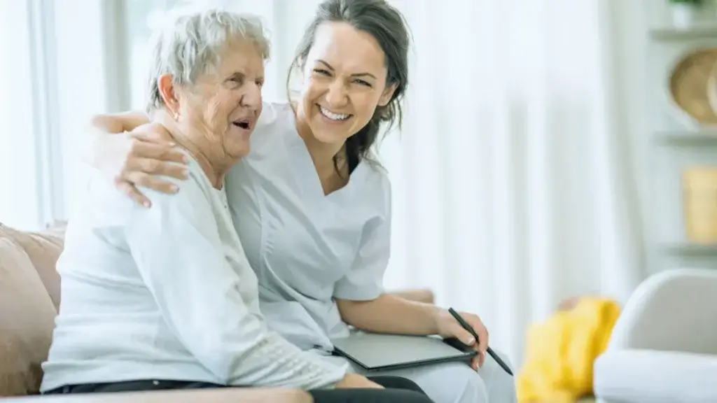 Support worker spending time with an older person in a comfortable home setting