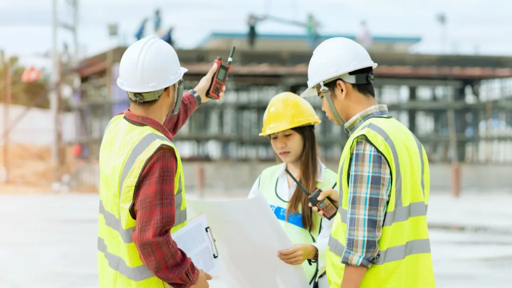 Surveyor using a total station on a construction site