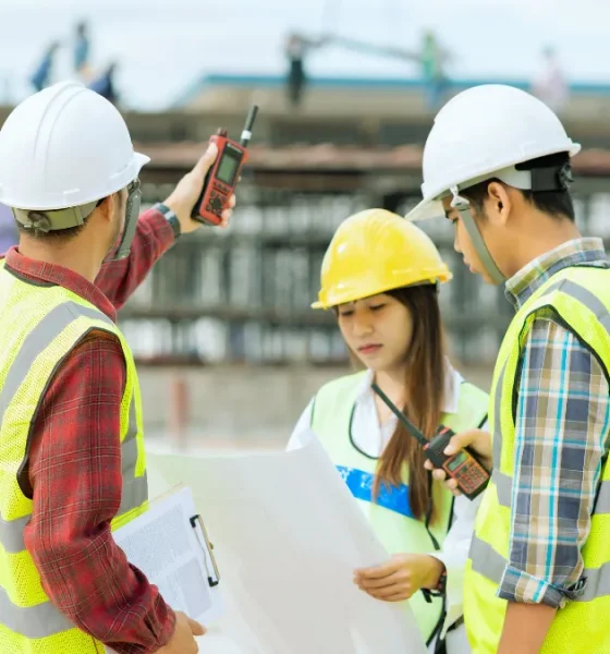 Surveyor using a total station on a construction site