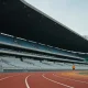 red running track and grandstand of an athletics stadium