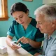 community nurse showing an older person a blood glucose meter