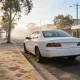 A white cab waiting on a quiet country-town main street in the morning.