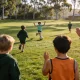 school children playing an inclusive PE game on an Australian oval