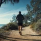 person walking a eucalyptus-lined coastal bush track