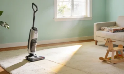 Bright Australian family living room with a cream carpet in a sunbeam and a vacuum cleaner standing ready