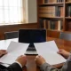 A lawyer and an accountant reviewing papers together at a table in a law office.