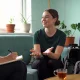 A support coordinator and a young woman having an NDIS planning conversation in a bright home living room.