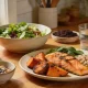 spread of salmon, salad, nuts and citrus on a kitchen table