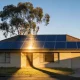 rooftop solar panels on an Australian house in late sun